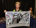 Jenette Goldstein holds up a poster for Terminator 2-Flickr.jpg